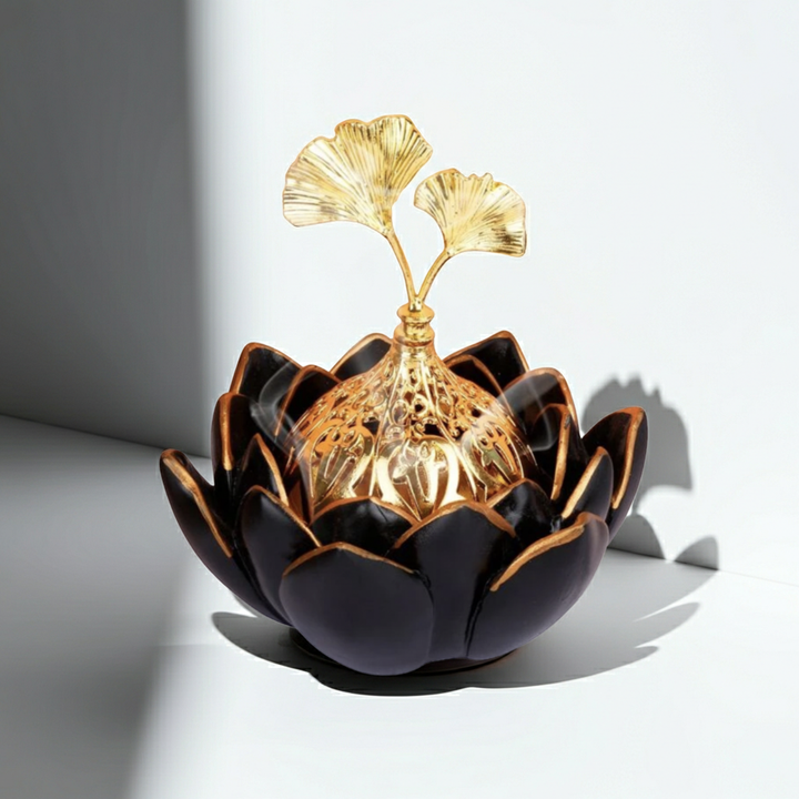 Decorative object with black and gold design on a white background