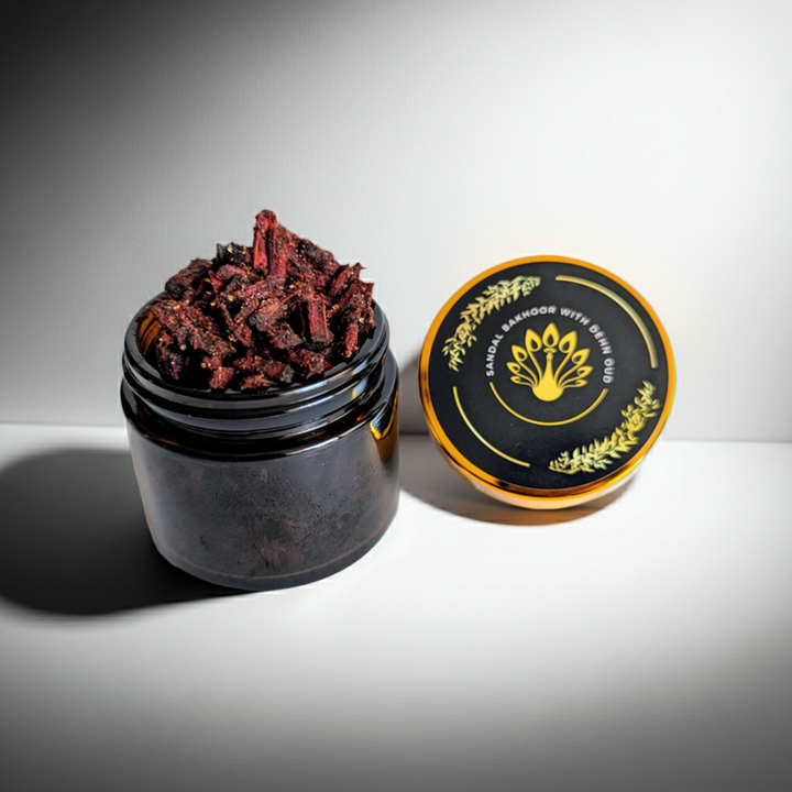 Black container with dried herbs and a black lid on a white background