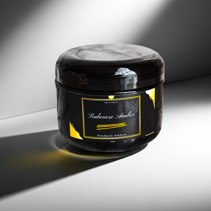 Black jar with a gold label on a gray background