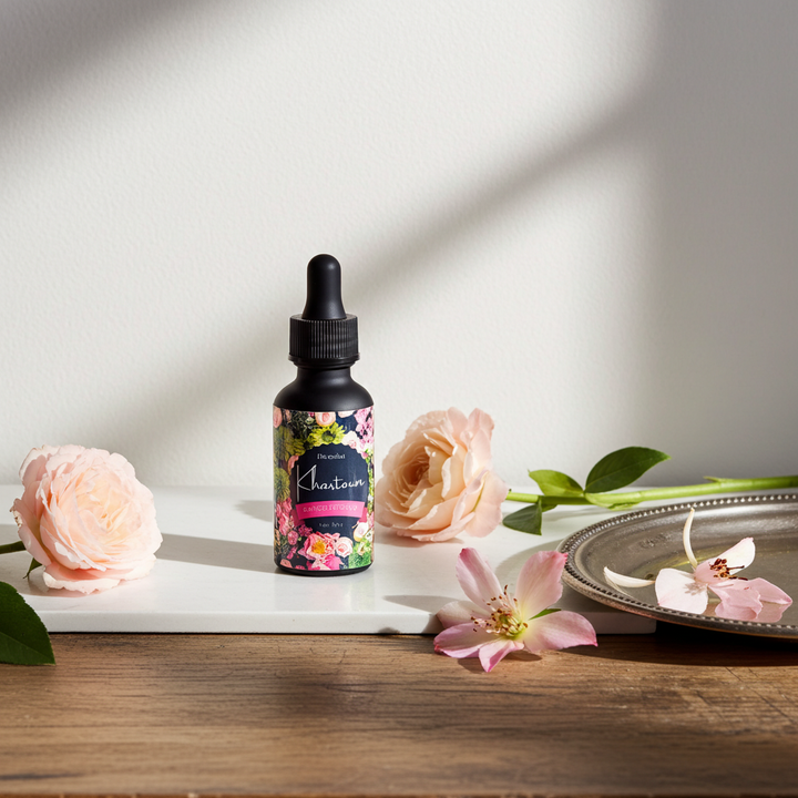 Bottle of Shantara skincare product with flowers on a wooden surface