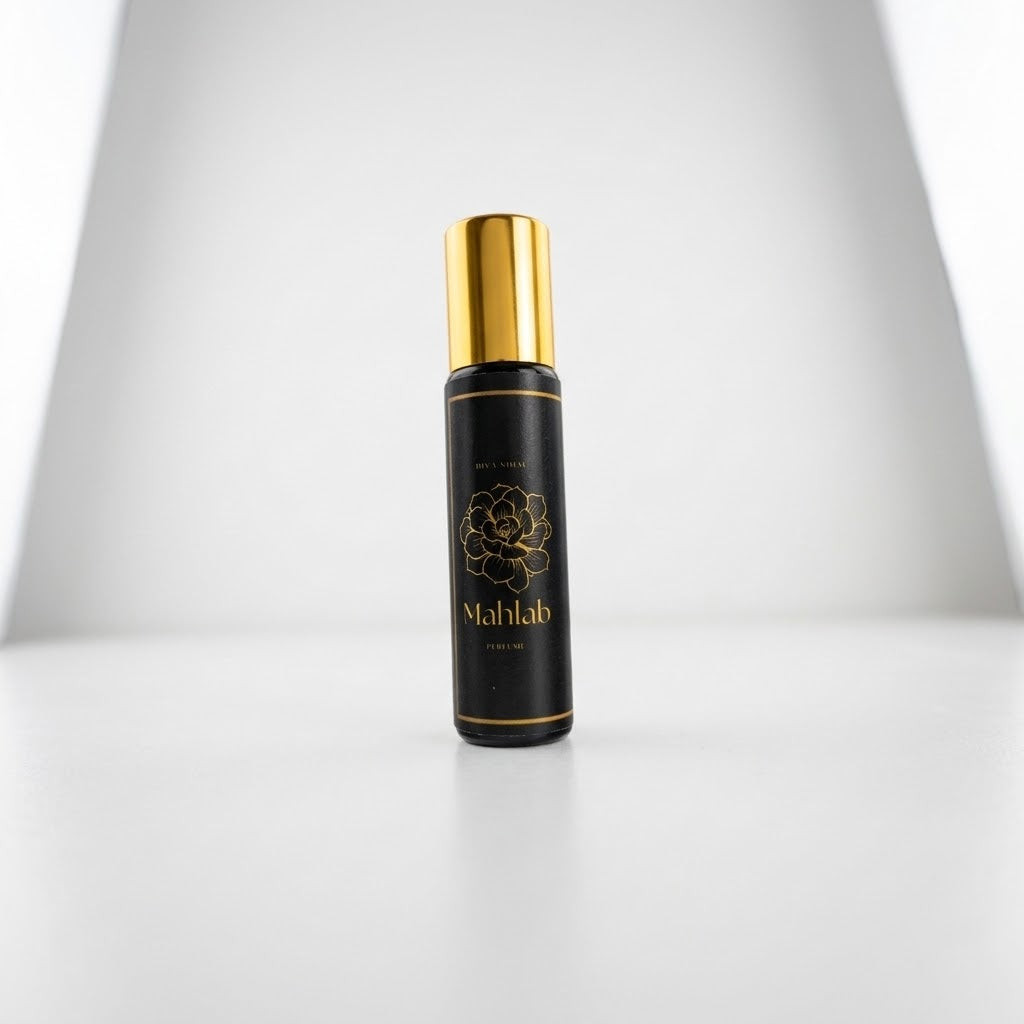 A black cylindrical cosmetic bottle with a shiny gold cap, featuring a gold floral emblem and the brand name &