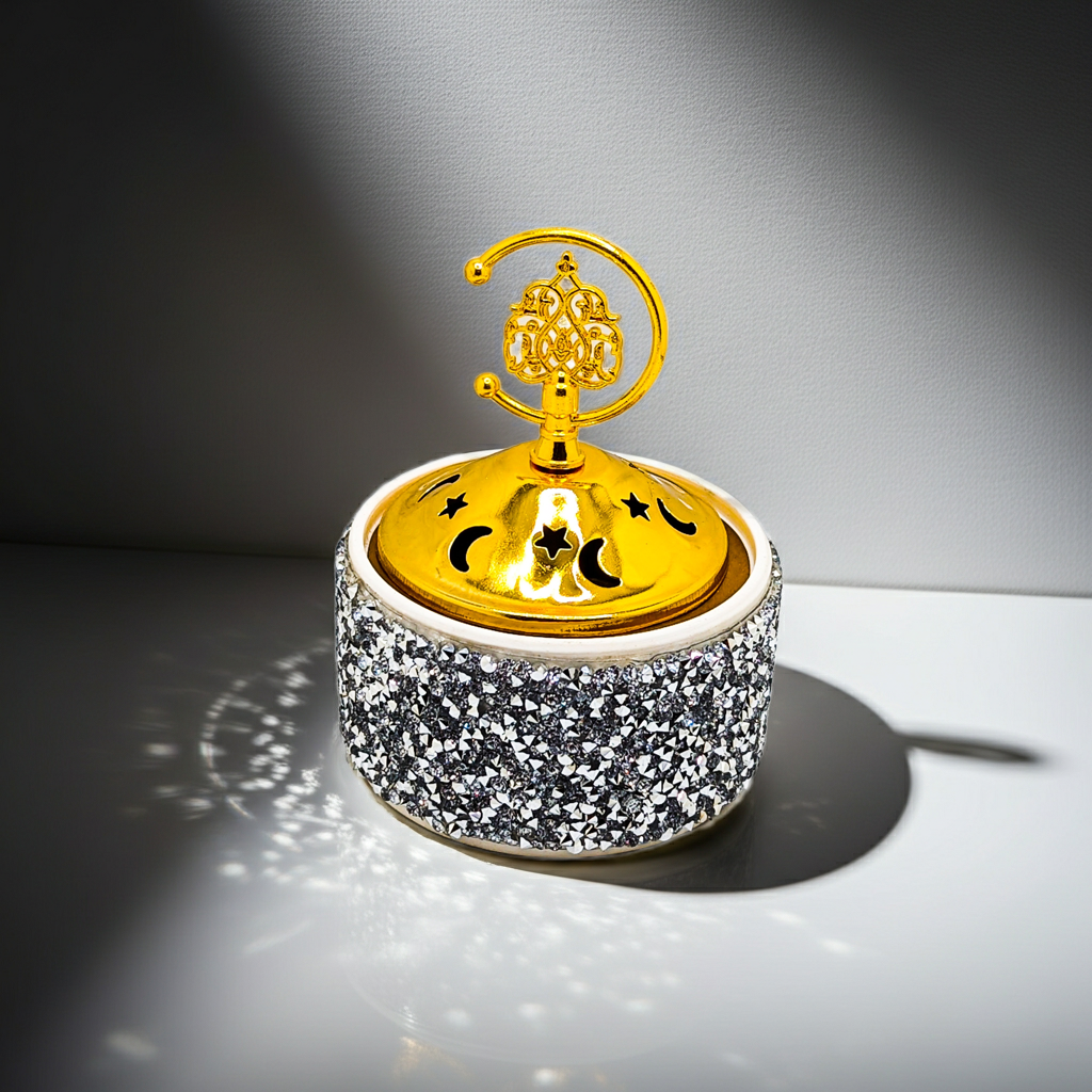 Decorative object with gold top and silver glittery base on a gray background