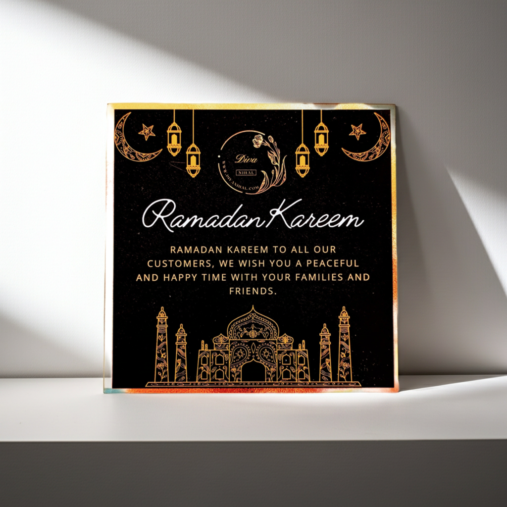 A square black Ramadan greeting card or plaque with elegant gold foil-style illustrations and text reading &