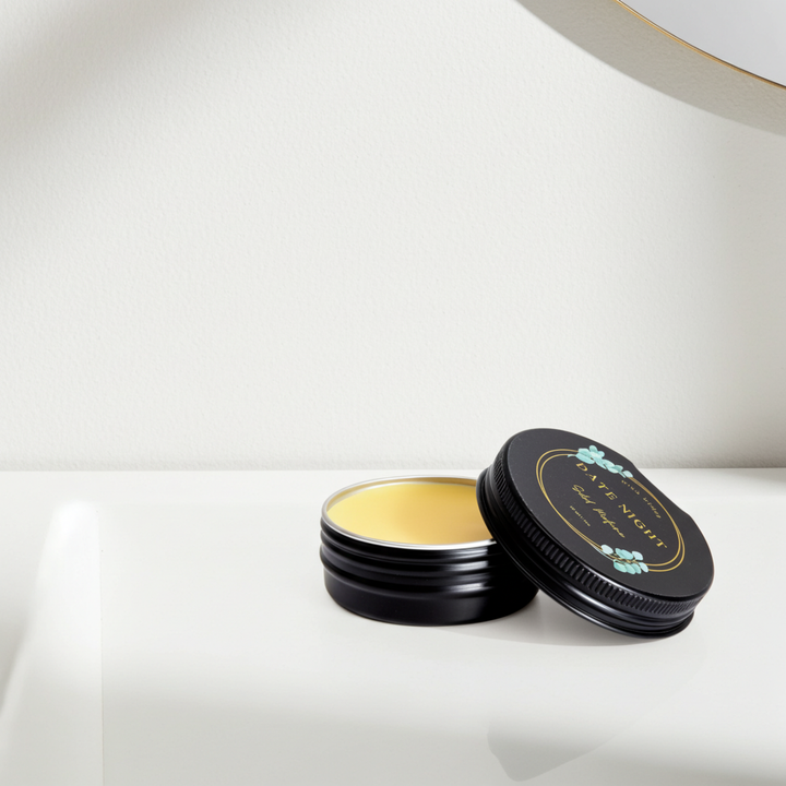 Black tin with a gold interior on a white surface