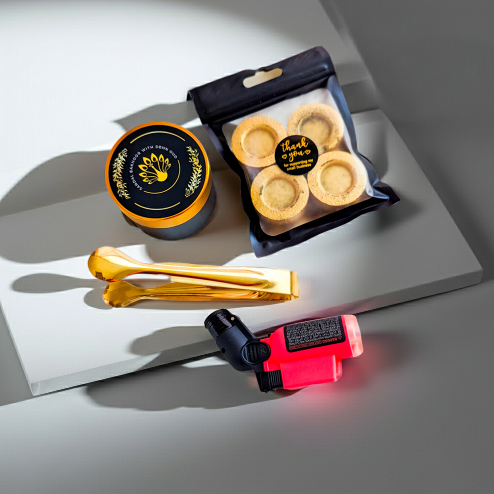 Packaged cookies, a container, tongs, and a small tool on a gray surface.
