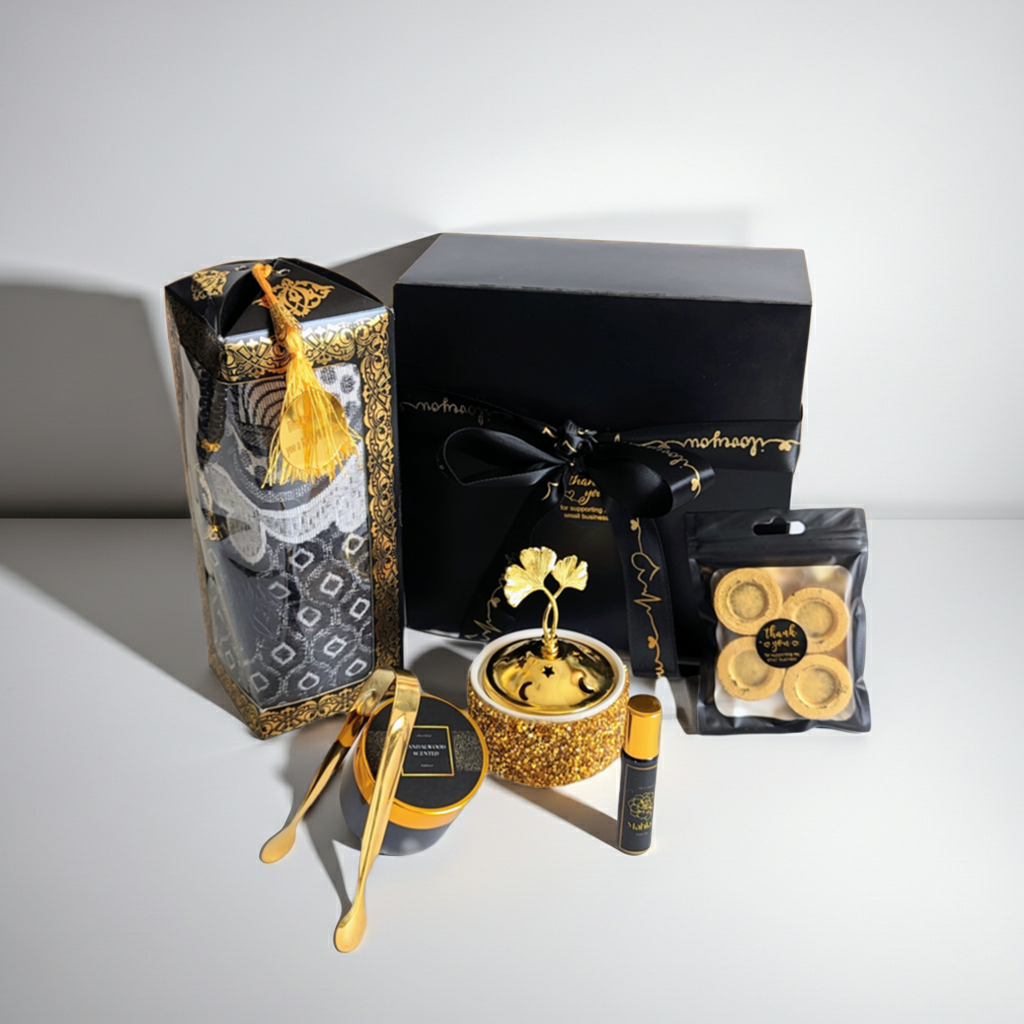 Luxury gift set with black and gold packaging on a white background