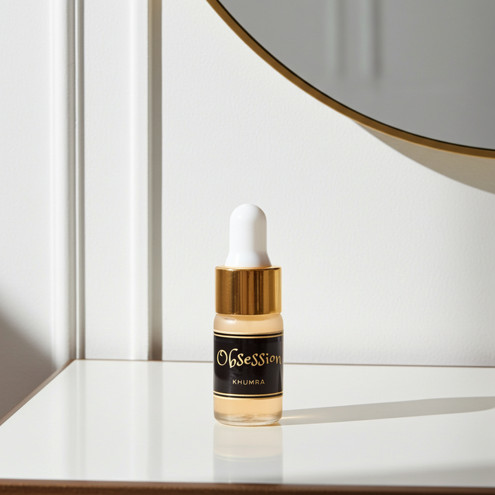Skincare serum bottle with gold cap and black label on a white surface